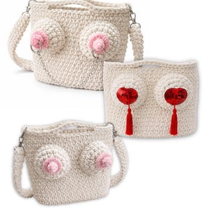 May include: Off-white crochet handbags with breast-shaped designs. Some bags feature pink nipple details with silver rings and chains. Another bag has red heart-shaped embellishments with red tassels.