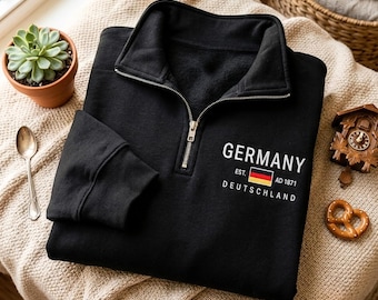 Sudadera con cremallera de un cuarto bordada con la inscripción "Deutschland", recuerdo de viaje a Alemania.