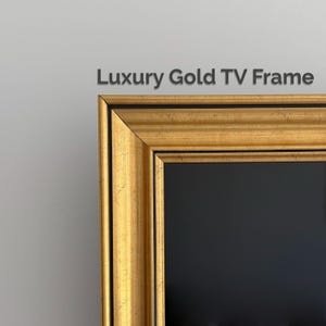 May include: A gold TV frame with a textured metallic finish and black inner detailing. The frame features a multi-layered molding design with clean mitered corners. The text Luxury Gold TV Frame is visible above the upper edge of the frame.
