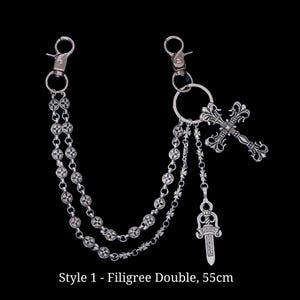 May include: Silver filigree double chain with two lobster claw clasps. The chain features decorative links and a cross pendant with a dagger charm. The text "Style 1 - Filigree Double, 55cm" is at the bottom.