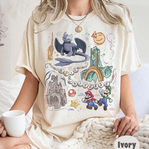 Retro Epic Universe Comfort Colors Shirt, Vintage Orlando Park Epic Universe Tee, Coquette Bow Mario Baby Tee, How To Train Your Dragon image 1
