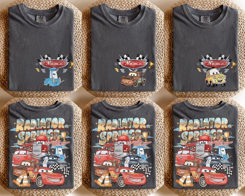 May include: Six dark grey t-shirts with various designs. The top row features cartoon cars with the word "Name" above them. The bottom row has a design with the words "Radiator Springs" and various cartoon cars.