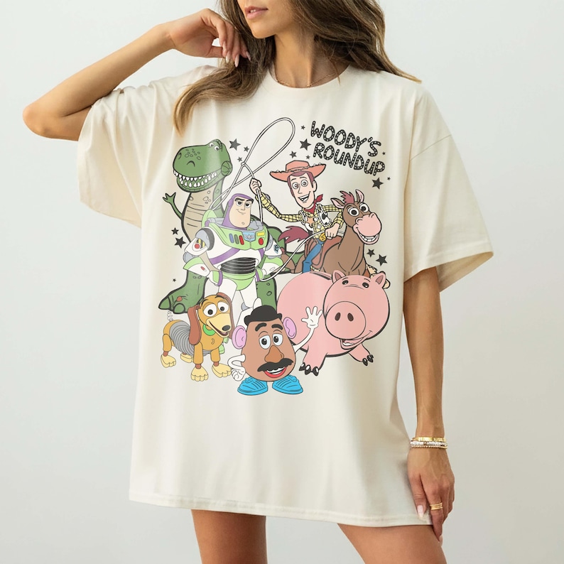 May include: A white ceramic mug with a black handle and the text "But First, Coffee" in a black, handwritten-style font. The mug is on a white surface.