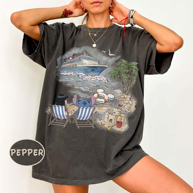 May include: Dark gray t-shirt featuring a colorful beach scene with a cruise ship, palm trees, and cartoon characters. The shirt has a distressed look and the word "PEPPER" is printed on the bottom left.