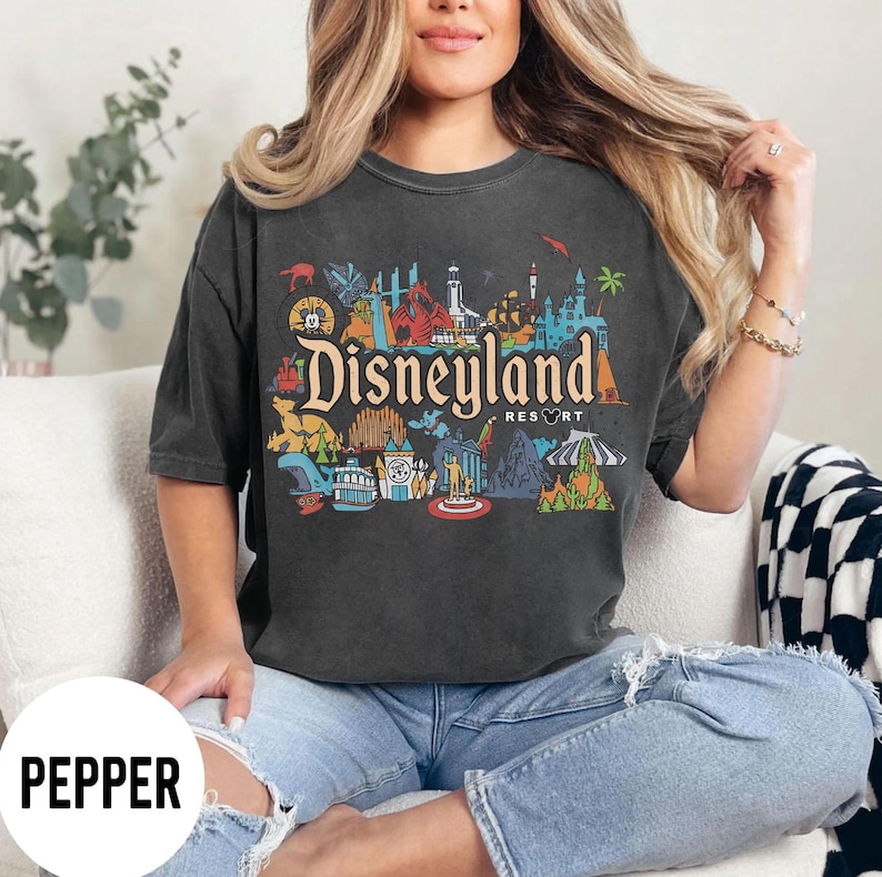 May include: A white ceramic mug with a black handle and the text "But First, Coffee" in a handwritten style. The mug is likely for hot beverages and has a glossy finish.