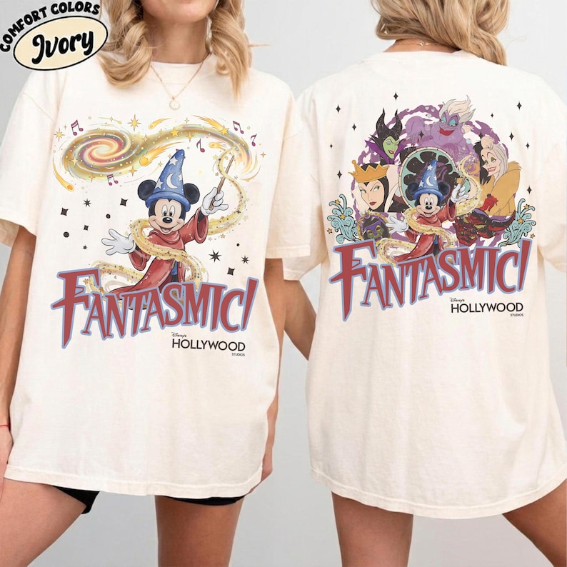 May include: Ivory-colored t-shirt featuring Mickey Mouse as a sorcerer with the text "Fantasmic!" in red and blue. The back of the shirt shows Disney villains. The shirt is from Disney's Hollywood Studios.