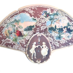 May include: A vintage lace fan with a brown and white design. The fan features a couple dancing in the centre and two scenes of people in a garden setting.