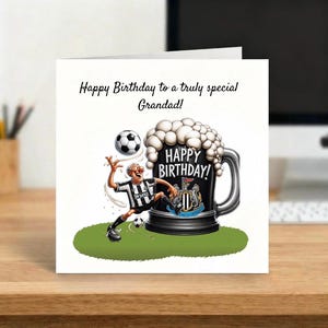 May include: A birthday card with the text "Happy Birthday to a truly special Grandad!" features a cartoon of a soccer player and a large beer mug with the words "Happy Birthday!" The card has a white background.