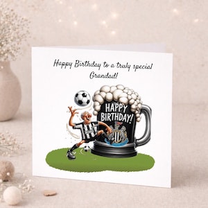 May include: A birthday card featuring a cartoon illustration. The card shows a soccer-themed design with a soccer player kicking a ball, a large beer mug with the words "Happy Birthday!" and the text "Happy Birthday to a truly special Grandad!"
