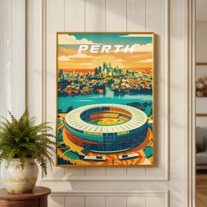 May include: A framed art print depicting Perth, Australia, in a stylized illustration. The artwork includes a stadium, cityscape, and river, with the city name in white block letters. The colour scheme features blues, oranges, and yellows.