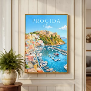May include: A framed wall art print depicting the coastal town of Procida, Italy, with colorful buildings on a hillside overlooking a harbor filled with boats. The sky is bright blue with white text reading PROCIDA Italy in a serif font.