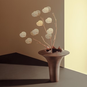 May include: A white ceramic mug with a black handle and the text "But First, Coffee" in a black, bold font. The mug is sitting on a wooden surface. The mug is approximately 4 inches tall.