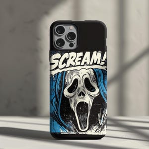 May include: A black smartphone case featuring a graphic illustration of a white ghost-like mask with a wide open mouth and dark eye sockets, wearing a blue hood. The word SCREAM! is printed in bold white letters above the mask design.