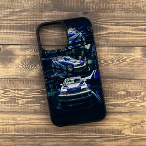 May include: Black phone case featuring a design of blue and white race cars. The case has a glossy finish and a black border. The cars are depicted in a dynamic, action-oriented style, suggesting speed and movement. The overall theme is automotive.