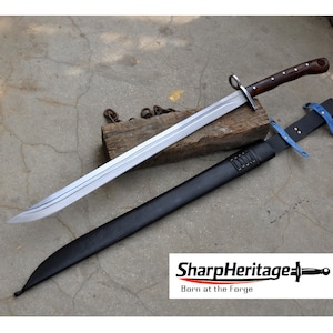 May include: A long, silver blade sword with a dark wooden handle and a black sheath. The sword rests on a piece of wood, with a chain in the background. The sheath has blue accents. The logo "SharpHeritage" is visible.