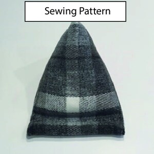 May include: A black and white plaid fabric sewing pattern for a triangular pillow. The pattern is for a pillow with a pointed top and a flat bottom.