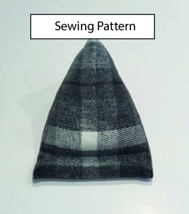 May include: A black and white plaid fabric sewing pattern for a triangular pillow. The pattern is for a pillow with a pointed top and a flat bottom.
