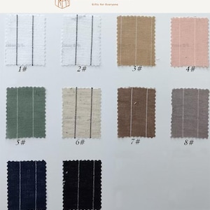 May include: A collection of ten rectangular fabric swatches arranged in a grid, each featuring vertical pinstripes. The colors include white, beige, pink, sage green, light brown, dark brown, grey, navy blue, and black, all with scalloped edges.
