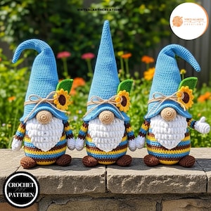 May include: Three crochet gnomes with blue hats, white beards, and striped bodies in yellow, blue, and brown. Each gnome has a sunflower accent and a brown nose. The gnomes are displayed on a brick wall with a garden background. The text "CROCHET PATTREN" is in a circle at the bottom.