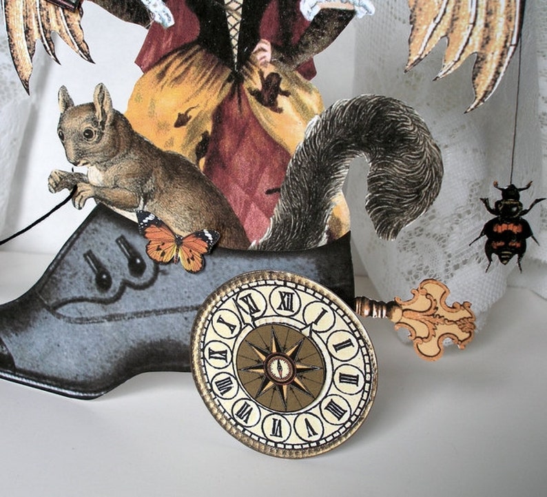 May include: A whimsical mixed media art piece featuring a woman with wings, a squirrel, a clock face, and a beetle. The woman is wearing a long dress with a floral pattern and a crown. The squirrel is sitting on a large black shoe. The clock face is attached to the shoe with a key. The beetle is perched on a white lace fabric.