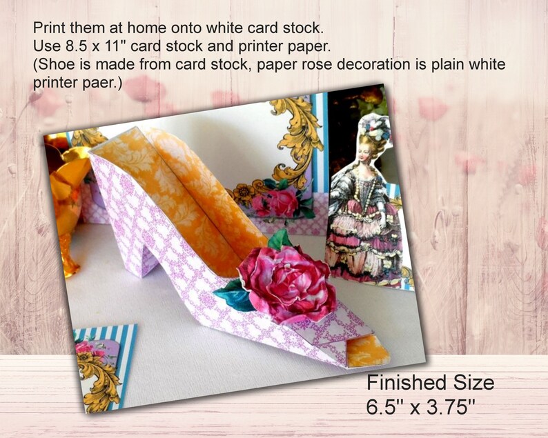 May include: A 3D papercraft shoe with a pink and white patterned design. The shoe has a pink rose decoration and a yellow interior. The finished size is 6.5 inches by 3.75 inches.