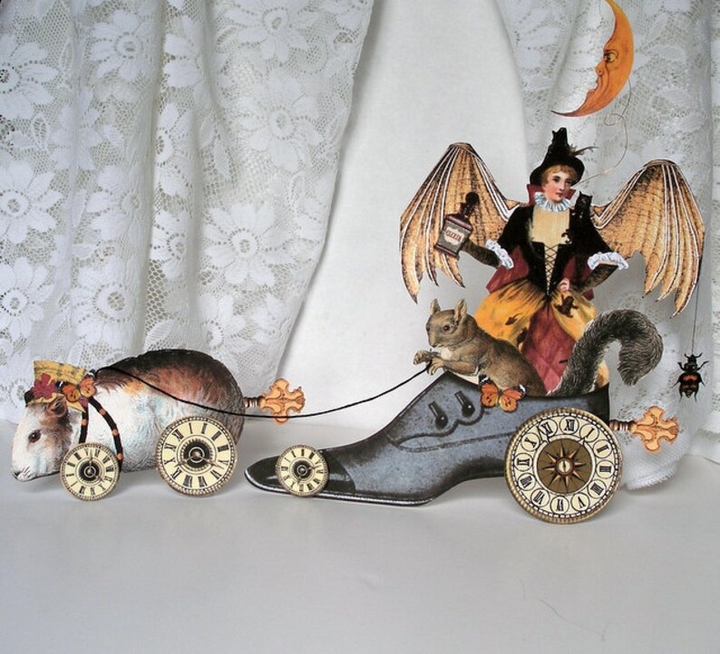 May include: A whimsical, handmade, papercraft sculpture of a winged fairy riding a clockwork shoe, pulling a guinea pig in a carriage with clockwork wheels. The fairy is holding a bottle and is accompanied by a squirrel.