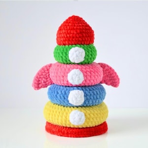 May include: A set of three ceramic mugs with a speckled, matte finish. The mugs are in shades of cream, light gray, and dark gray. Each mug has a simple, minimalist design and a rounded handle.