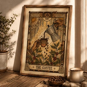 May include: Framed art print featuring a coffee-themed tarot card design. The artwork depicts hands pouring coffee into a cup, surrounded by coffee beans and plants. The text "THE COFFEE" is at the bottom. The print is in a wooden frame.