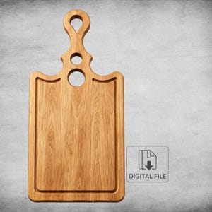 May include: A light brown wooden cutting board with a handle featuring a keyhole design and two circular cutouts. The rectangular board has a recessed border. The image includes a small icon with the text "DIGITAL FILE".