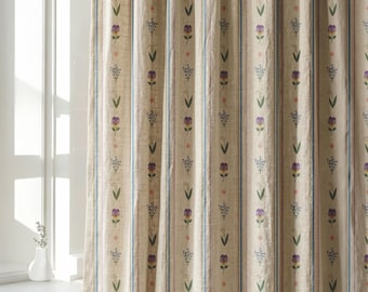 May include: A beige curtain featuring vertical stripes in blue and brown, decorated with a repeating pattern of small purple pansies, green leaves, and delicate white lily of the valley flowers arranged in a structured, linear vertical layout.