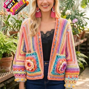 May include: A colorful, open-front crochet jacket with a floral design on the pockets. The jacket features a rainbow of colors, including pink, orange, yellow, and blue. The sleeves have a textured design. The image also includes a "Buy 1 Get 1 Free" promotion.