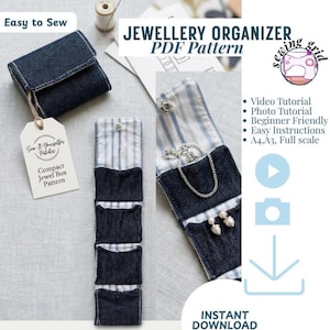 May include: A sewing PDF pattern for a compact jewelry organizer made from dark blue denim fabric with a light blue and white striped interior lining. The organizer features multiple small pockets, a snap closure, and a white paper tag.