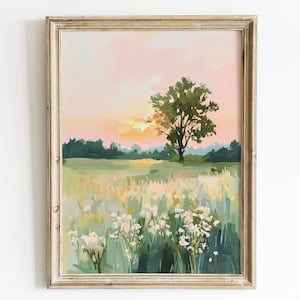Puede incluir: Impresión artística enmarcada que representa un paisaje de pradera. La obra de arte muestra un árbol verde, un campo de flores silvestres y un cielo de atardecer en tonos rosados y anaranjados. El marco es de color claro y neutro, realzando los tonos naturales de la obra.