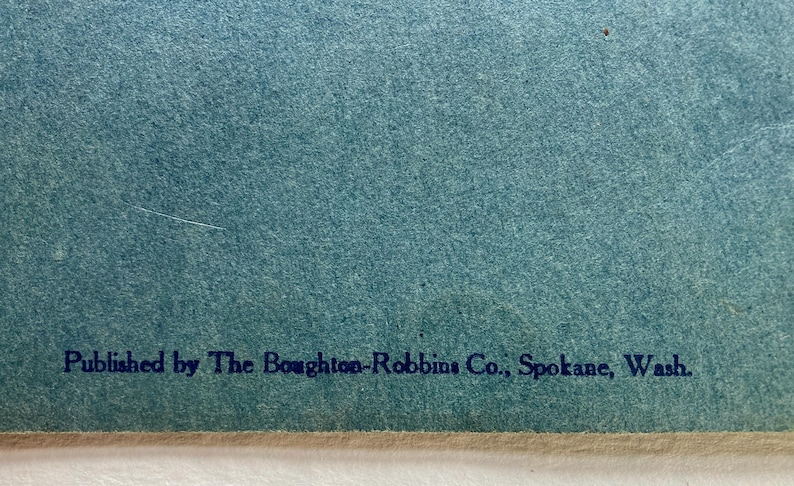 Op de afbeelding: Blauw papier met de tekst "Published by The Boughton-Robbins Co., Spokane, Wash."