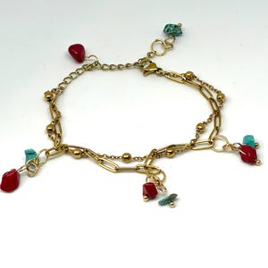 Gold coloured double link bracelet with red and turquoise irregular beads
