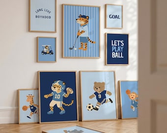 May include: A collection of nine framed wall art prints featuring cartoon animals playing sports. The prints include a tiger golfing, a leopard playing football, a bear playing soccer, a giraffe and monkey playing basketball, and text reading Long Live Boyhood, Goal, and Let's Play Ball.