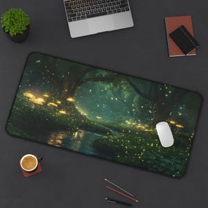 May include: A rectangular mouse pad featuring a fantasy forest scene with glowing mushrooms and fireflies. The artwork is predominantly green and dark, with a river and trees. A white computer mouse rests on the pad.