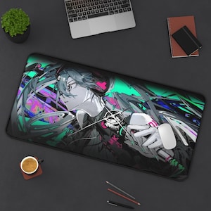 May include: A large black mousepad featuring a colorful anime-style illustration of a character with long, flowing hair. The design incorporates shades of teal, pink, and purple. A white mouse rests on the pad, next to a laptop.