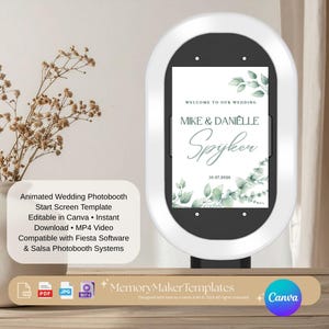 May include: A white oval digital photobooth kiosk displaying a wedding welcome screen template with green eucalyptus leaf graphics and the text Welcome to our wedding, Mike & Danielle Spijker, 10.07.2026 on a vertical screen with a black border.