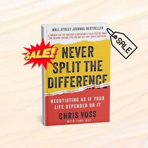 May include: A hardcover book titled "Never Split the Difference" by Chris Voss. The book has a yellow and red cover with the title in large black letters. The book is labeled as a Wall Street Journal Bestseller and includes the text "Negotiating as if your life depended on it."