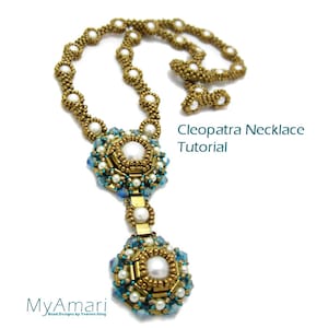 May include: A gold and blue beaded necklace with a large pendant featuring a white pearl surrounded by gold and blue beads. The necklace is called "Cleopatra Necklace Tutorial".
