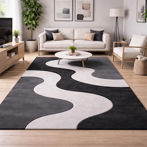 Puede incluir: Un juego de tres tazas de cerámica con un acabado moteado y mate. Las tazas son de color crema, gris claro y gris oscuro. Cada taza tiene un diseño simple y moderno y un asa redondeada. Las tazas están apiladas.