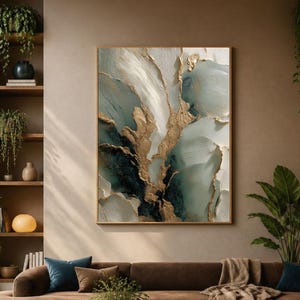 May include: A large rectangular wall art piece featuring abstract swirls of white, teal, and dark blue with metallic gold accents. The painting is displayed above a brown sectional sofa, a low wooden coffee table, and a blue armchair in a room.