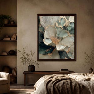 May include: A square framed wall art piece featuring an abstract floral composition in shades of deep teal, soft cream, and white, accented with metallic gold veining. The artwork is displayed on a neutral wall above a wooden bench in a bedroom.