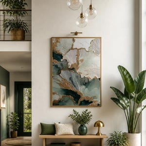 May include: A large rectangular wall art piece featuring abstract swirls of deep teal, white, and metallic gold paint. The artwork is framed in light wood and hangs on a white wall above a wooden bench with green and cream pillows and a lamp.