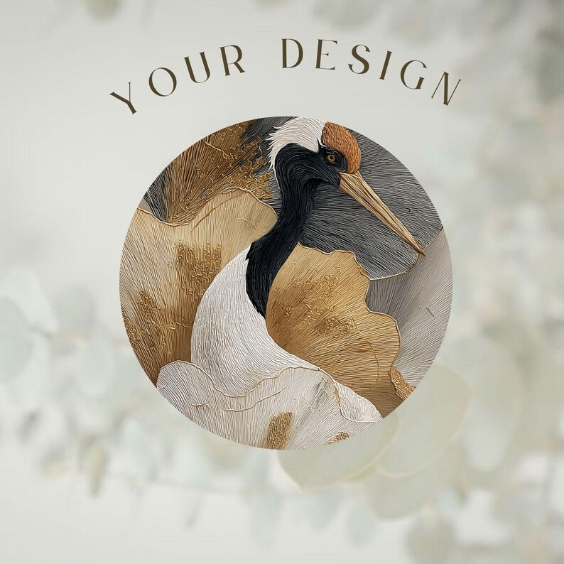 May include: A circular graphic featuring a detailed illustration of a red-crowned crane with black, white, and gold textured plumage. The text YOUR DESIGN is printed in a dark brown serif font above the circular artwork on a light background.