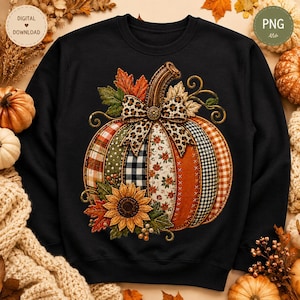 May include: A black long-sleeve sweatshirt featuring a large central graphic of a pumpkin composed of various fabric patterns including plaid, gingham, and floral prints. The pumpkin is adorned with a leopard print bow and a yellow sunflower.