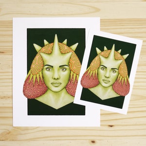 May include: A print of a stylized illustration of a person with a green face and a crown of spikes. The person has pink and yellow patterned hair. The print is on white paper with a white border.