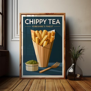 May include: A framed poster featuring a graphic illustration of a paper cone filled with golden-brown french fries, a small bowl of green mushy peas, and a wooden fork. The text reads CHIPPY TEA YORKSHIRE'S FINEST against a dark blue background.