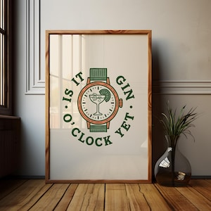 May include: A framed wall art print featuring a graphic illustration of a wristwatch with a cocktail glass inside the dial. The text "IS IT GIN O'CLOCK YET" is printed in dark green capital letters around the watch face, which includes a lime wedge.